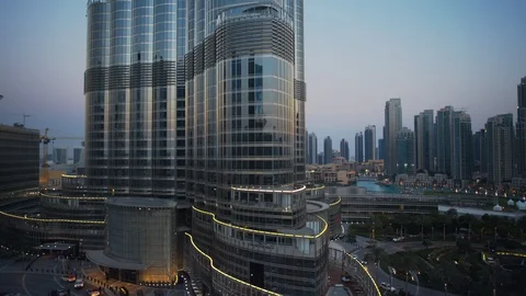 Track left past base of Burj Khalifa at 60m, sunset/evening, dusk. Stock Footage 98953664