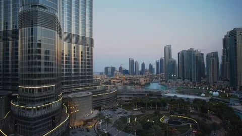 Track left past base of Burj Khalifa at 60m, sunset/evening, dusk. Stock Footage 98954514