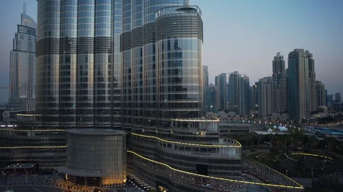 Track left past base of Burj Khalifa at 60m, sunset/evening, dusk. Stock Footage 98954618