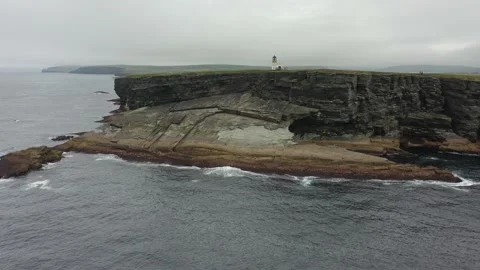 Track into lighthouse Brough Head Birsay Orkney Scotland sea cliffs dramatic Stock Footage 159825087