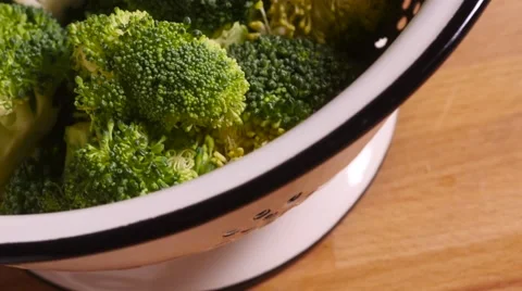 Track over broccoli florets in colander Stock Footage 55454243