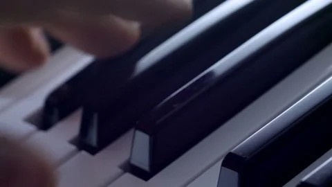 Track over man playing piano keyboard Stock Footage 77536033