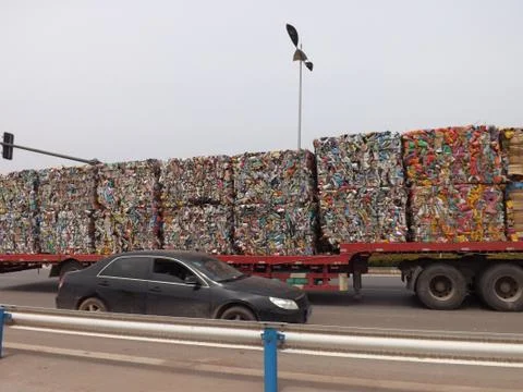 The track with pressed cubes of garbage on the highway Stock Photos