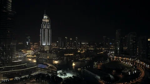 Track right while descending from 100m down to 50m from Burj Kahlifa past Dubai Stock Footage 98961447