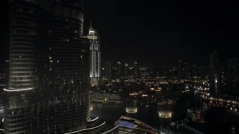 Track right while descending from 150m down to 100m from Burj Kahlifa past Dubai Stock Footage 98960761