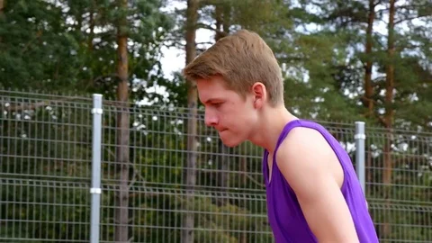 Track runner boy teenager running in a stadium, steadicam shot Stock Footage