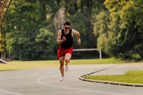 Track runner doing sprints during the training for the 100m race Stock Photos