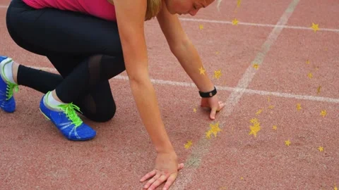 Track runner sliding hands to lane mark, shifting forward preparing start, star Stock Footage 335739522