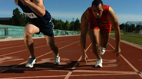 Track runners at starting line, slow motion Stock Footage