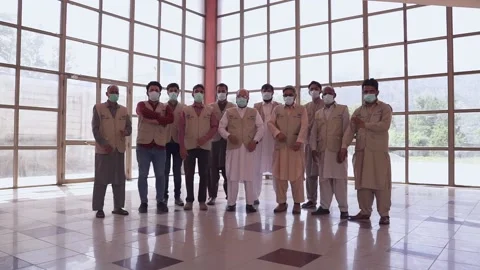 Track in shot, as team stands together in a hall showcasing their unity and stre Stock Footage 166169212