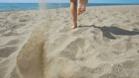 Track shot on the woman's legs while walking in the beach Stock Footage 112398865