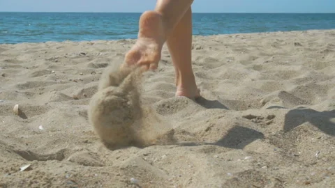 Track shot on the woman's legs while walking in the beach Stock Footage 112399857