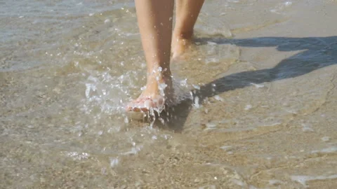 Track shot on the woman's legs while walking in the beach Stock Footage 112402820