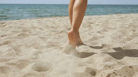 Track shot on the woman's legs while walking in the beach Stock Footage 112404915