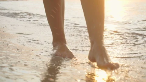 Track shot on the woman's legs while walking in the beach Stock Footage 112416711