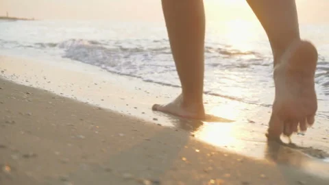 Track shot on the woman's legs while walking in the beach Stock Footage 112417787
