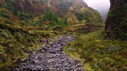 Track trail through mountains walking by muddy paths after rain amidst nature Stockbeeldmateriaal 237692183