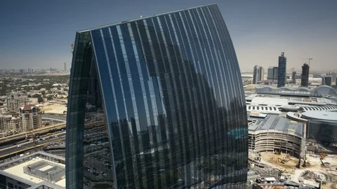 Track tright past Emaar Square, Dubai Mall and Burj Khalifa at 100m. Stock Footage 98926726