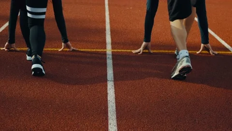 Track two runner putting his hands at starting line man woman Stock Footage 115963601