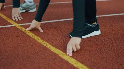 Track two runner putting his hands at starting line man woman Stock Footage 115964228