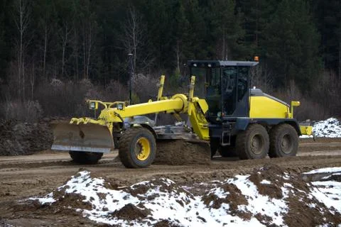 Track-type bulldozer machine doing earthmoving work at sand quarry . Stock Photos