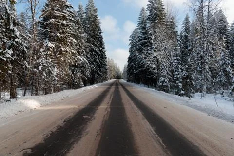 Track in winter time in the middle of the forest Stock Photos