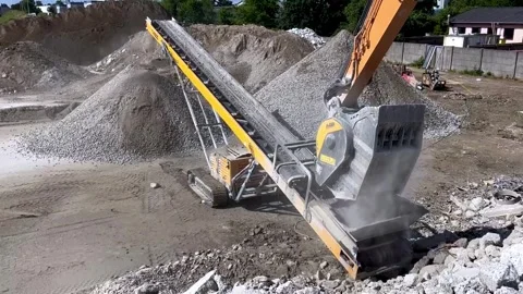 Tracked Conveyor Belt Machine Loading Raw Aggregates in Industrial Quarry Stock Footage 338119320