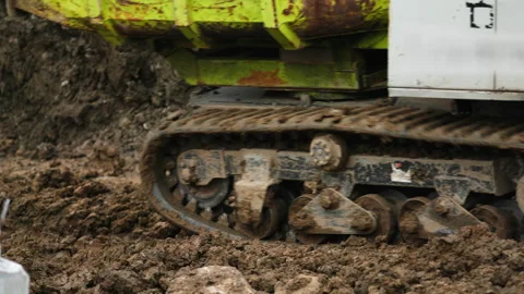 Tracked Dumper Undercarriage Moving Through Muddy Construction Site Stock Footage 336220455