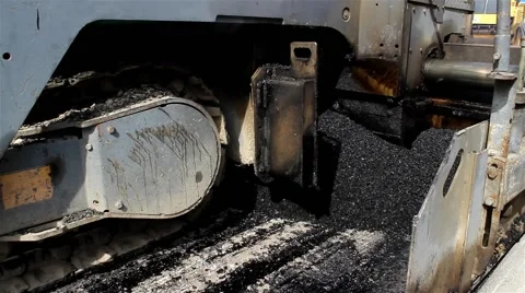 Tracked machine for paving apply asphalt to road. Tracking shot. Close up. 25fps Stock Footage 41458870