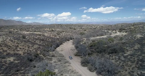 Tracking a 4x4 off road van driving along dirt track  drone aerial 4K Stock Footage 111313410