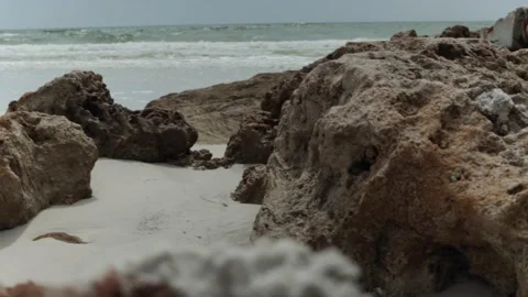 Tracking across sea rocks with ocean waves crashing in the background Stock Footage 139752080
