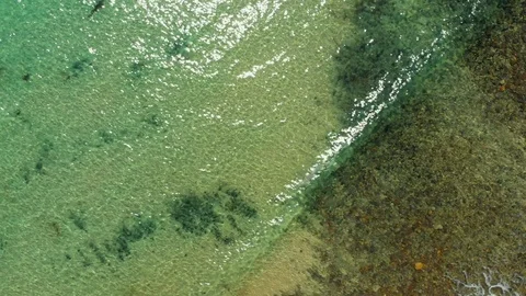 Tracking Aerial, looking down over emerald coloured ocean in South Australia Stock Footage 124238569