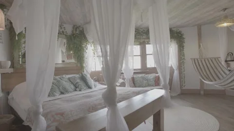 Tracking and panning shot of open, bright and nature decorated bedroom Stock Footage 202132784