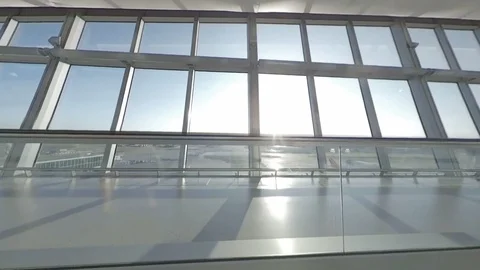 Tracking and rising shot from window to busy airport below Stock Footage 118251560