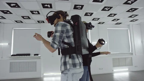 Tracking arc 360 degree shot of a young man and woman standing back to back in Stock Footage 123314137