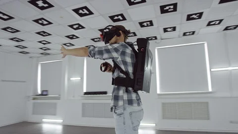 Tracking arc 360 degree shot of a young man shaking his hand and aiming in Stock Footage 127850842