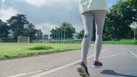Tracking athlete engaged in physical exercise running on outdoor treadmill. Stock Footage 218240231