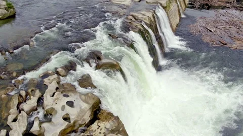 Tracking back across a waterfall and then around the front Stock Footage 155469050