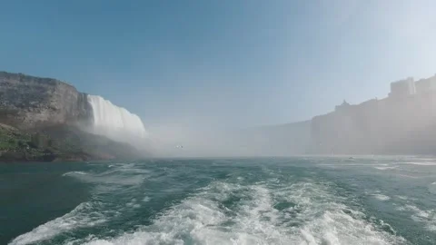 Tracking back from Niagara Falls, boat wake in mist and bright haze Stock Footage 320002828