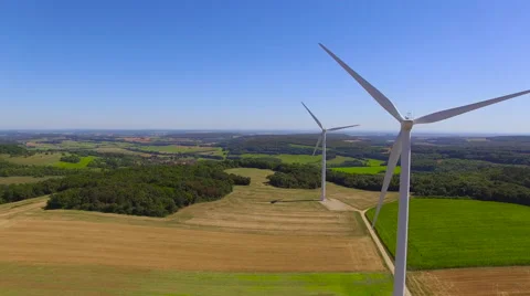 Tracking Behind Spinning Wind Turbines 4K Stock Footage 66910885