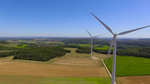 Tracking Behind Spinning Wind Turbines Stock Footage 66912788