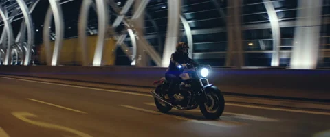 TRACKING Biker riding his custom built motorcycle through city at night Stock Footage 202095960