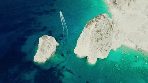Tracking a boat from aerial view through the rocks of Myzithres. Stock Footage 240620025