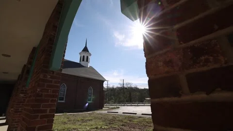 Tracking By Brick Column To Reveal Sun Flare Over Church Building 스톡 동영상 315226709