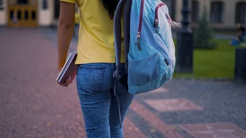 Tracking camera. An alarmed student in a yellow T-shirt is slowly going to Stock Footage 127667512