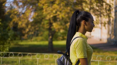 Tracking camera. Cheerful student walks on campus 4K Stock Footage 127661108