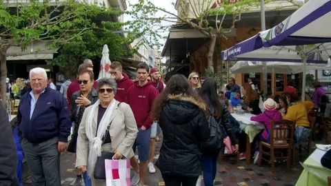 Tracking camera forward in narrow streets of old town among crowd of people Stock Footage 92440446