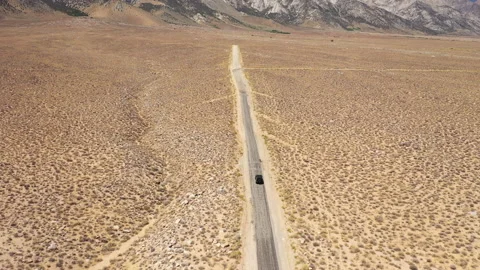 Tracking a car overhead on a desert road Stock Footage 142796358