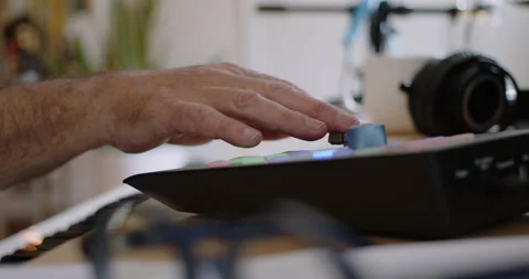 Tracking close-up of fingers tapping automation buttons and fader Stock Footage 234757660