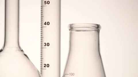 Tracking close-up shot of empty chemical glass flasks and test tube against Stock Footage 75939989